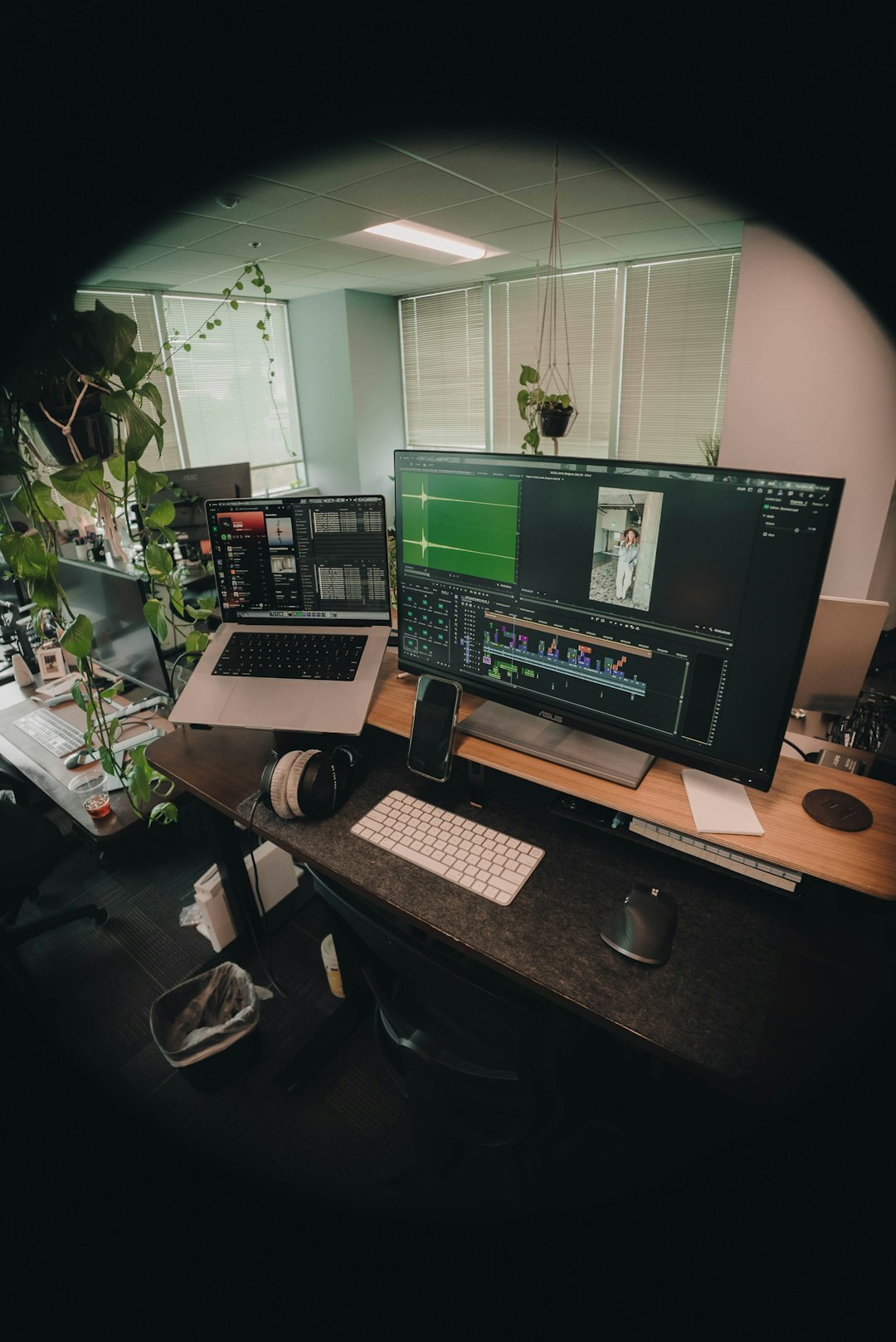 video editor at desk with multiple screens